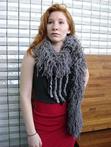 Mlle. Bellisant models a gray boa-like scarf.